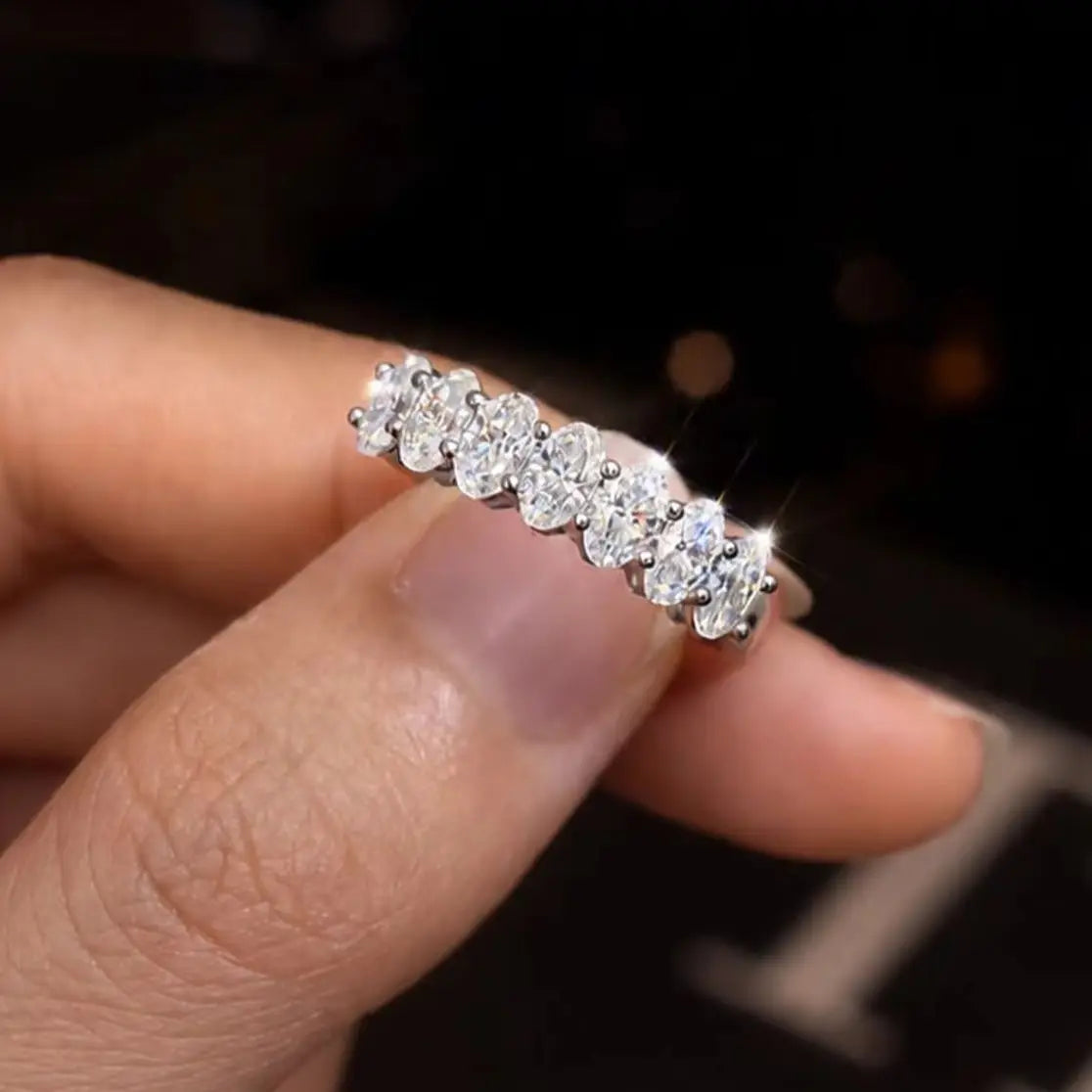 A Simple Unisex Couple's Ring in 925 Sterling Silver with a 2.1-Carat Oval Moissanite, Perfect for Dates and Parties.